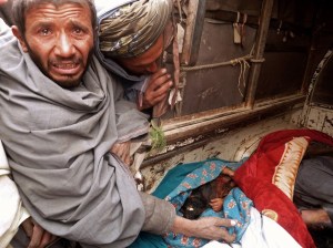 A mourner cries over the bodies of Afgha